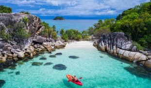 Aerial-drone-view-of-in-kayak-in-crystal-clear-lagoon-sea-water-during-summer-day-near-Koh-Lipe-island-in-Thailand-photo-via-Depositphotos.jpg